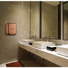 a bathroom with two sinks and a red hand towel dispenser