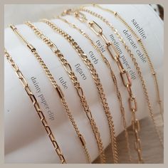 our high quality 18k gold filled necklace in various styles and lengths. very versatile and perfect staple for layering. Gold Chain Jewelry Women Layered, Lengths For Layering Necklaces, Gold Charm Necklaces With Figaro Chain For Layering, Gold Charm Necklace With Figaro Chain For Layering, Minimalist 14k Gold Filled Layered Necklace For Everyday, Cheap Long Layered Necklace With Delicate Chain, Minimalist Gold Charm Necklaces With Paperclip Chain, Minimalist Gold Charm Necklace With Paperclip Chain, Trendy Figaro Chain Jewelry For Layering