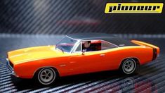 an orange and black muscle car on a table with the word pinner above it