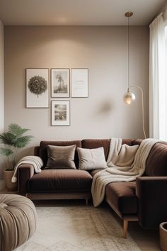 a living room filled with furniture and pictures hanging on the wall above it's windows