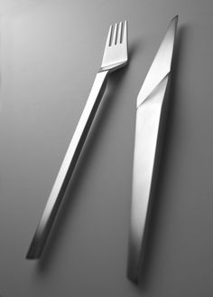 a knife, fork and spoon sitting on top of a table