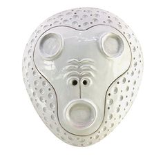 a white bear mask with holes on it's face and nose is shown against a white background