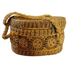 an old woven basket is shown on a white background and it's brown with yellow accents