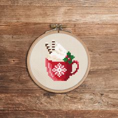 a cross stitch pattern with a cup of hot chocolate and marshmallows on it