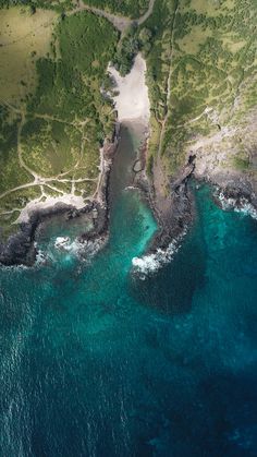 an aerial view of the ocean and land