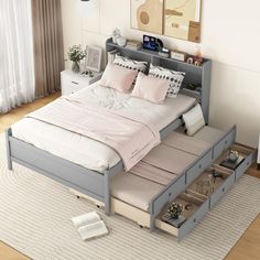 a bed with drawers underneath it and a white rug on the floor next to it