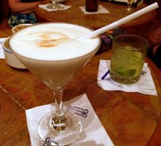 two drinks sitting on top of a wooden table