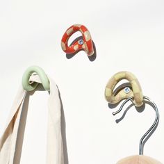 three different types of clothes hangers and one has a ring on the end of it