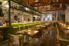 the interior of a restaurant with tables and chairs