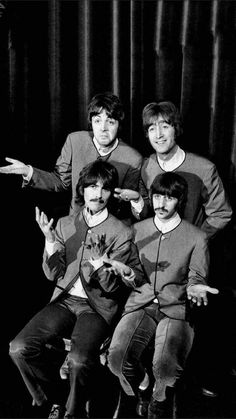 the beatles posing for a black and white photo