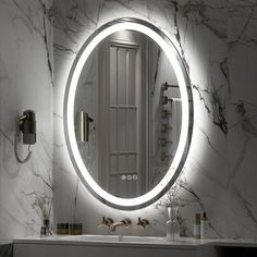 a bathroom sink with a round mirror above it