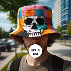 a man wearing a crocheted hat with a skull on it