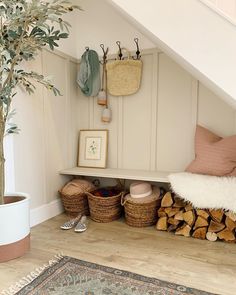 a room filled with lots of wood and baskets next to a plant on top of a shelf