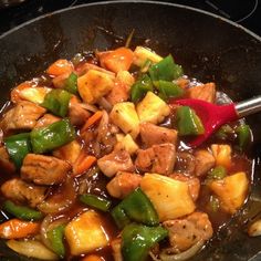 a pan filled with meat and vegetables on top of a stove