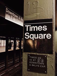 a sign on the side of a building that says times square