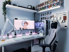 a computer desk topped with two monitors and a keyboard next to a monitor on top of a white desk