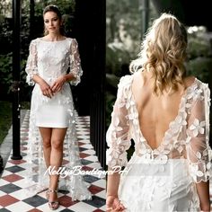 the back of a woman's dress with white flowers on it and in front of a black and white checkered floor