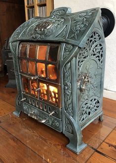 an old fashioned stove sitting on top of a wooden floor