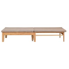 a wooden bench sitting on top of a white floor next to a beige cushioned seat