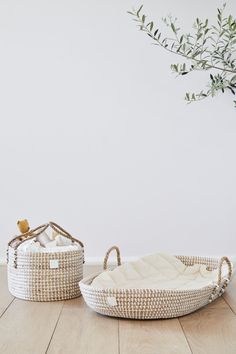 two wicker baskets sitting on top of a wooden floor