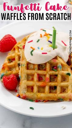 a waffle topped with whipped cream and sprinkles next to raspberries