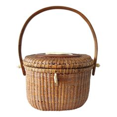 a wicker basket with wooden handles on a white background