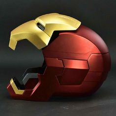 an iron man helmet on top of a red apple