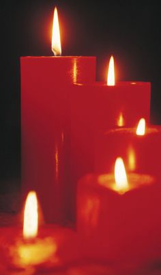 several lit candles sitting on top of a table