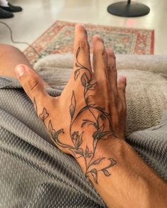 a man's hand with a tattoo on it