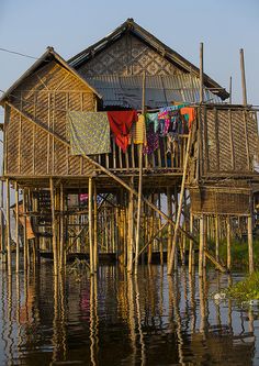 a house with clothes hanging out to dry in the water