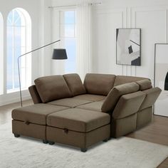 a living room with a sectional couch in the middle and a rug on the floor