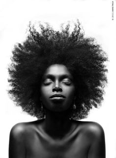 a woman with an afro is shown in black and white