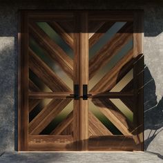 a pair of wooden doors sitting on top of a cement wall next to a plant