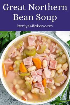 a white bowl filled with ham and bean soup on top of a blue table cloth