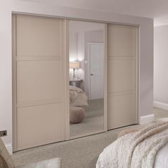 an empty bedroom with mirrored closet doors in it