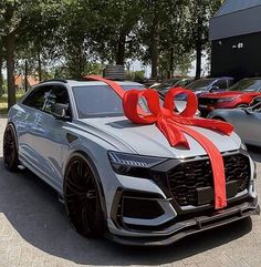 an audi car with a red bow on the hood