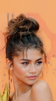 an image of a woman with her hair in a bun