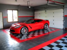 a red sports car parked in a garage with checkered floor and black and white tiles