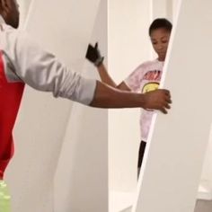 a man is painting the walls with white paint