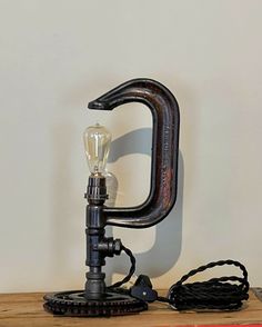 an old fashioned lamp sitting on top of a wooden table next to a light bulb