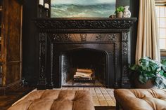 a living room filled with furniture and a fire place in front of a painting on the wall