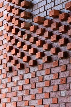 a red brick wall with several bricks attached to it