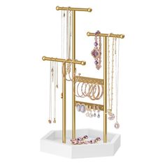 a gold jewelry rack with lots of necklaces and bracelets hanging from it's sides