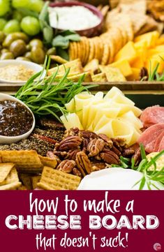 various types of cheeses, crackers and nuts on a platter with grapes