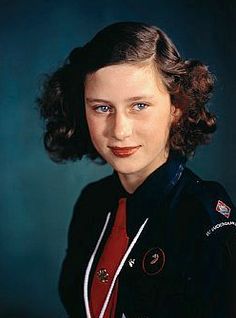 an old photo of a young woman with blue eyes and brown hair wearing a uniform