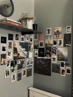 a bunch of pictures hanging on the wall next to a radiator in a bathroom