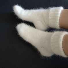 Very warm angora wool socks will keep your feet warm. The socks are thick. Also suitable for home  I can do in other colors. contact me beforehand Hand knit socks Very soft and warm socks. Socks will keep your feet warm in cold weather. Composition: angora (rabbit) yarn Size: choice a select Color: white naturale Ready to ship SIZE:  EU 36-37 (22-23 santimeters) - US 5-6 (8.7-9.1 inch) EU 38-39 (24-25 santimeters) - US 7-8 (9.5-9.8 inch) EU 40-41 (26-27 santimeters) - US 9-9.5 (10.2-10.6 inch) E Comfortable Thick Knitted Socks, Thick Knitted White Socks, Comfortable Hand Knitted Winter Socks, Thick Knitted Socks, Soft Round Toe Socks For Gifts, Thick Warm White Socks, Lovebrush Chronicles, Fluffy Bed, Emma Ross