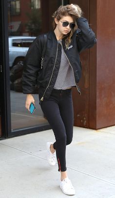 38 Celeb-Inspired Ways to Wear White Sneakers | People - Gigi Hadid in skinny black jeans, a striped shirt and black bomber jacket Dresses With Tennis Shoes, Casual White Sneakers, Sneakers Design, White Sneakers Outfit, Modest Casual, Outfit Sneakers, Jacket Ideas, Tennis Shoes Outfit, Black Jeans Outfit