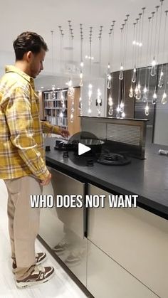 a man standing in front of a black counter top