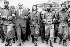 a group of men walking down a street in front of a sign that says kuba'da tepe camii onu, cuma gikisi